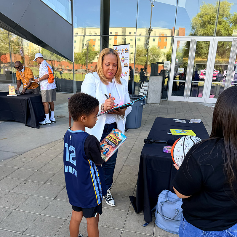 Helen Darling signing books for students
